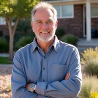 Mike proudly standing next to his newly xeriscaped front yard, showcasing vibrant, water-wise plants.